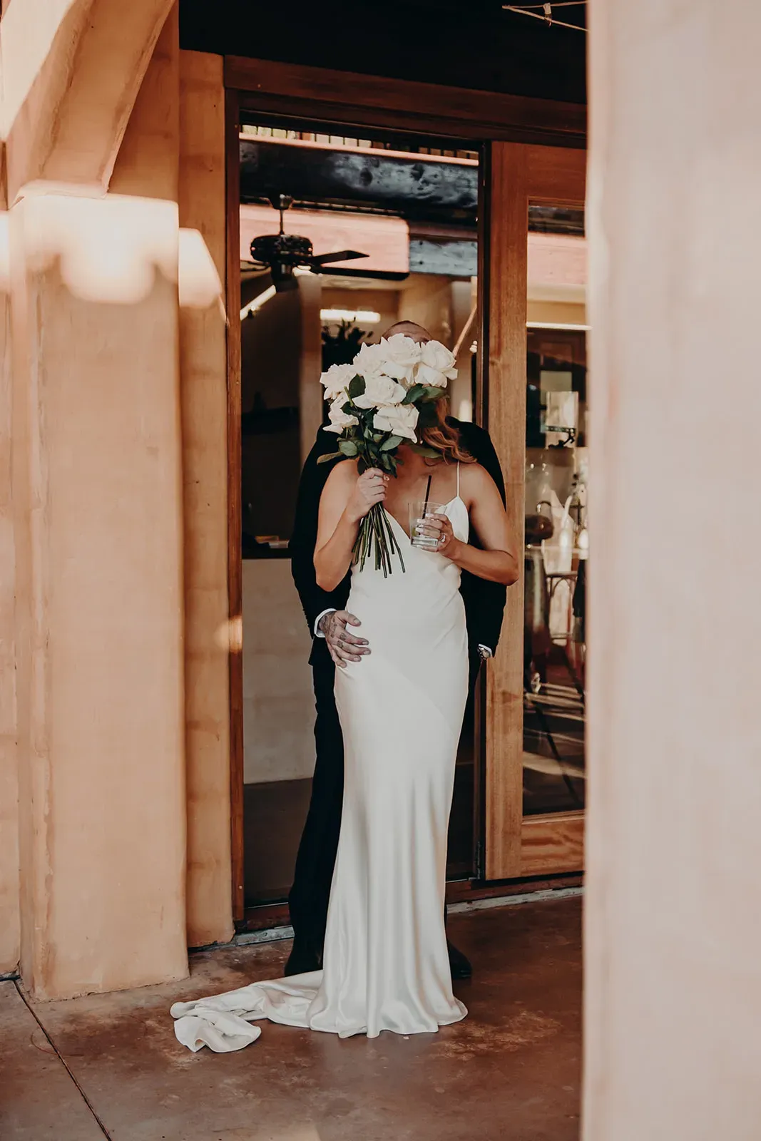 monique_josh_hiding_behind_bouquet_kiss_9199f9e560