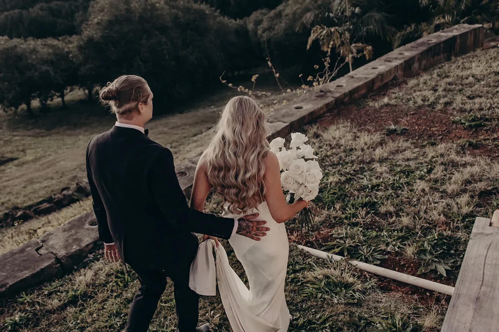 monique_josh_couple_walking_down_hill_back_view_5a76990188