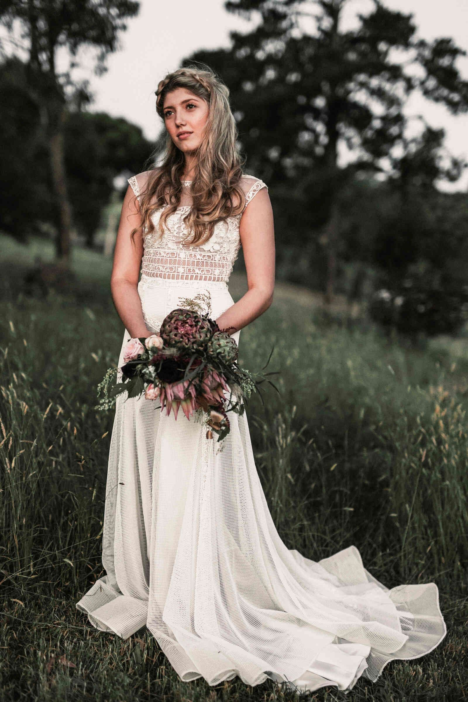 bride_standing_field_sleeveless_gown_ed619a9cfd