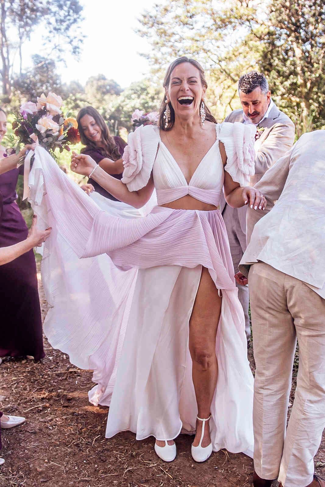 bride_skirt_toss_pink_two_piece_dress_laughing_outdoors_158aeccbf4