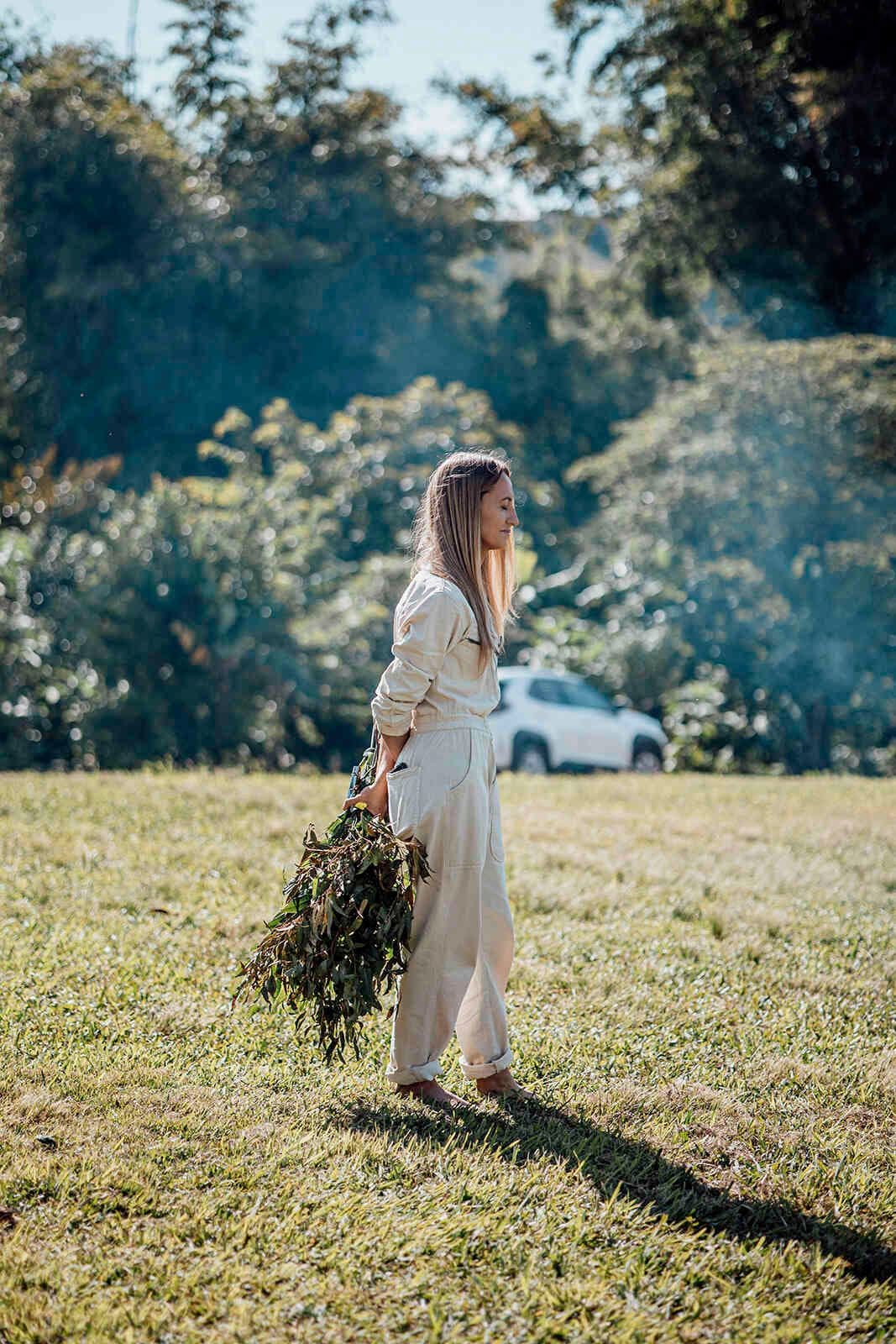 person_carrying_eucalyptus_leaves_bush_ceremony_preparation_74c5e02b73