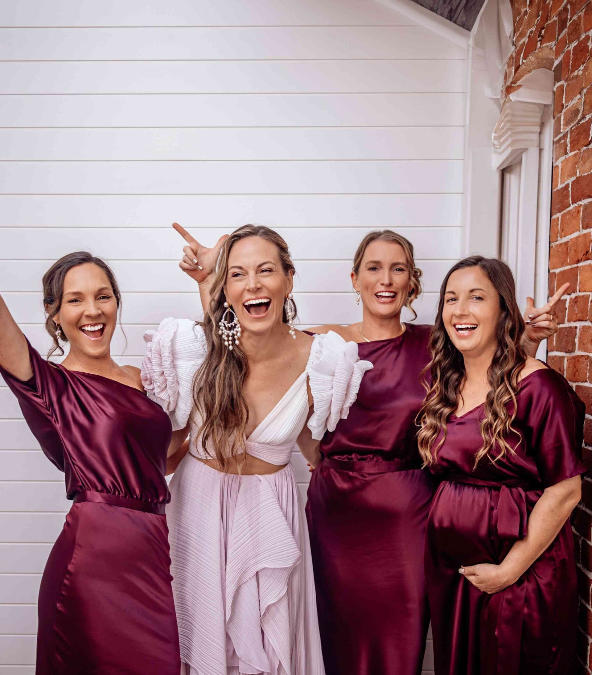 bride_bridesmaids_group_portrait_laughing_pink_burgundy_d926c70dde