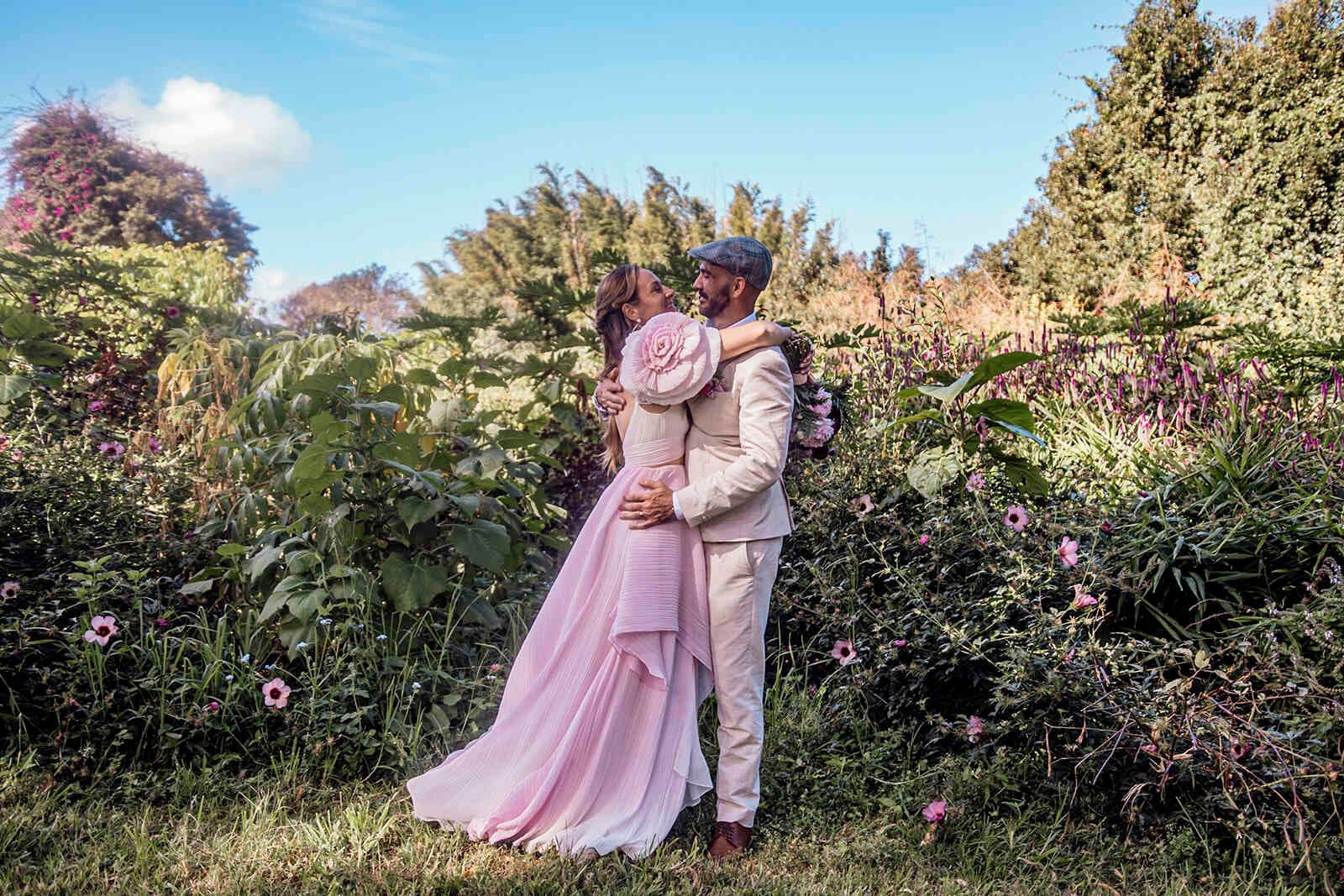 bride_groom_hugging_romantic_portrait_pink_dress_garden_006484c1bf