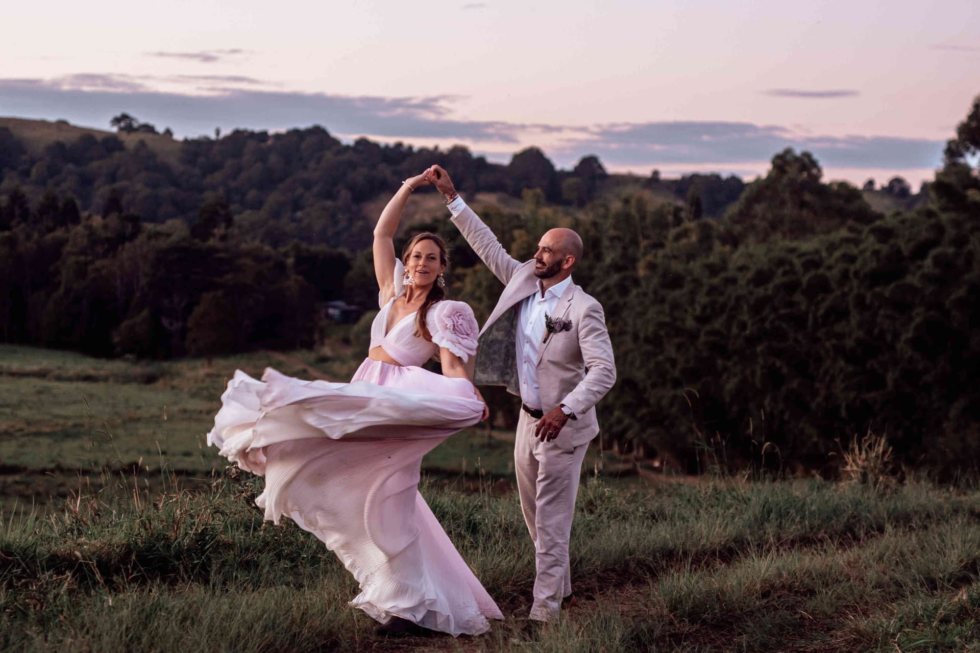 bride_groom_dancing_sunset_portrait_pink_dress_twirl_d6340d8b82