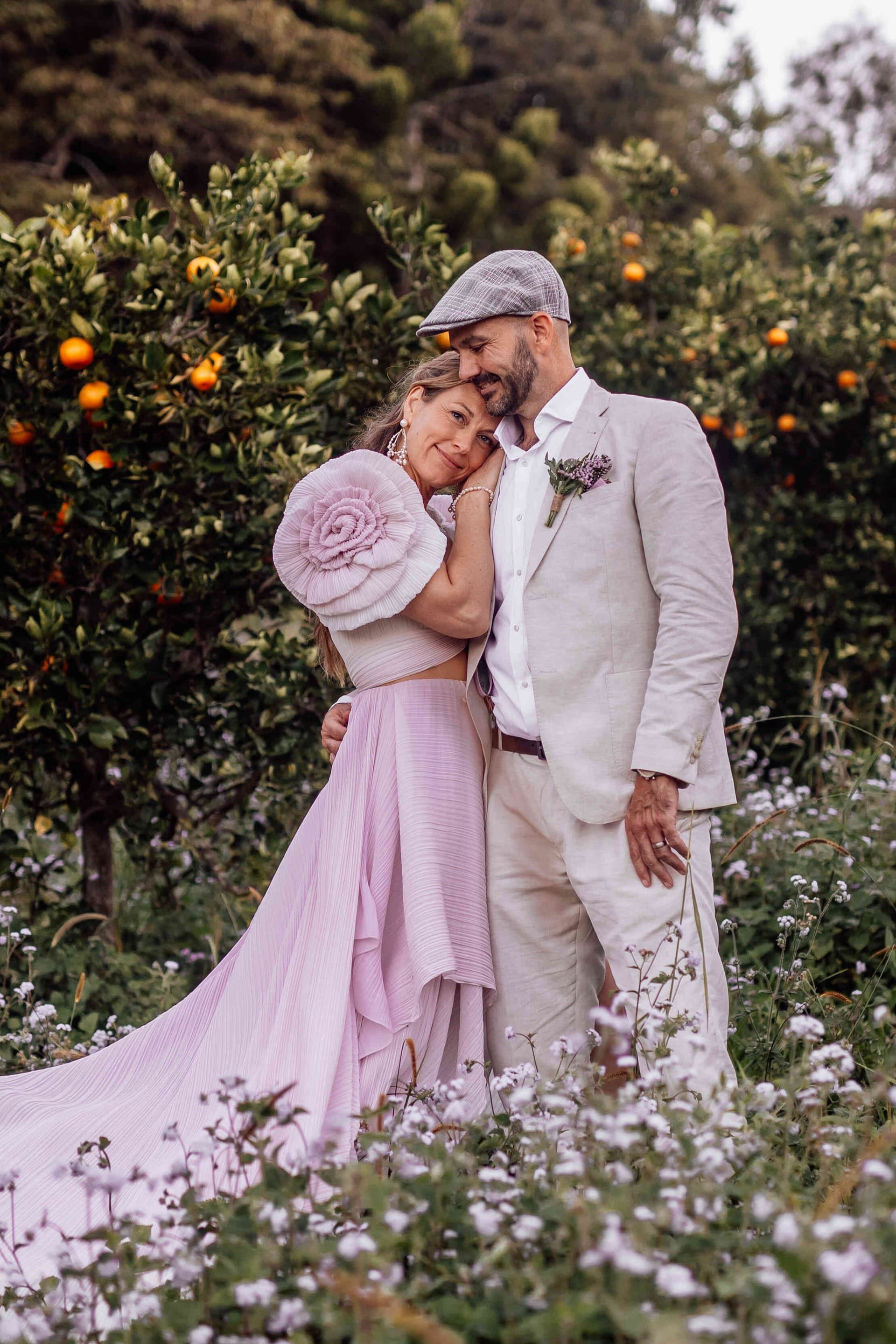 bride_groom_leaning_on_shoulder_orchard_flower_field_b20f36ca3f